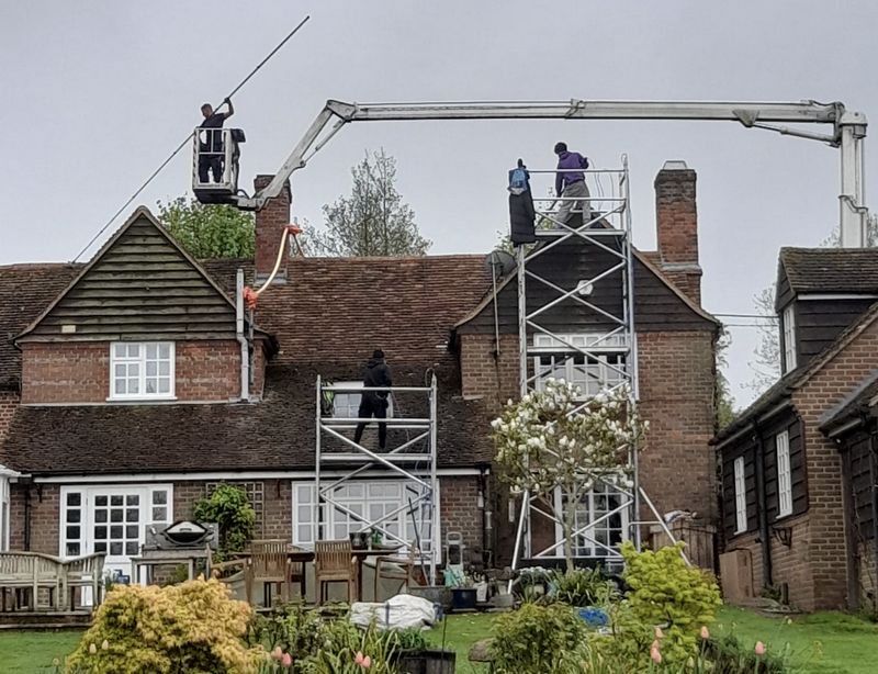 The Moss Cleaners using cherry picker and scaffolding to clean roof safely and professionally in Blackwater, Hampshire